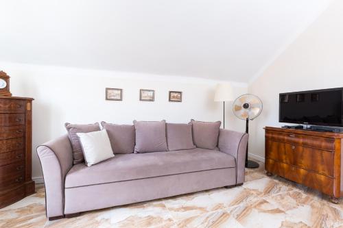 a living room with a couch and a tv at Royal Castle Square Apartment Old Town Warsaw Warszawa in Warsaw