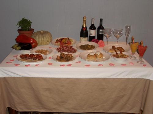 
a table topped with plates of food and drinks at Tierras de Moya in Los Huertos
