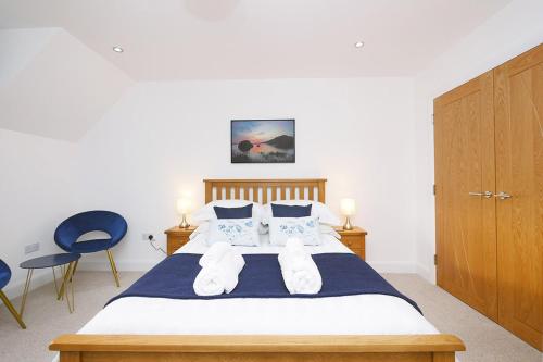 a bedroom with a bed with two pillows at Pinewood Cottage Apartment & B&B Inverness in Inverness