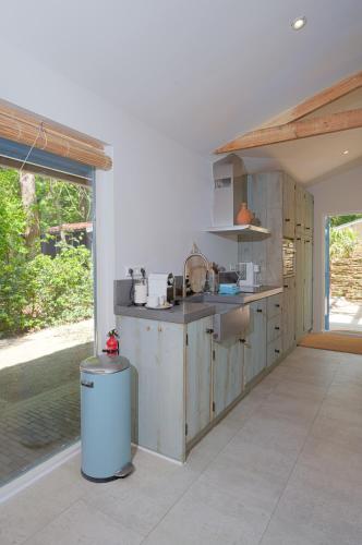 a kitchen with a sink and a counter top at ZEN-bungalow NO 2 met sauna en hottub in Rheezerveen