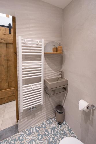 a bathroom with a sink and a toilet at ZEN-bungalow NO 2 met sauna en hottub in Rheezerveen