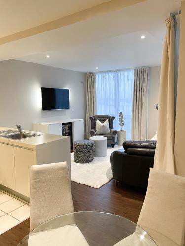 a living room with a couch and a table at NOVU Apartments Liverpool Waterfront in Liverpool