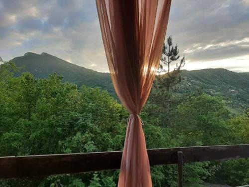 a curtain in a window with a view of a mountain at Vila Eva in Međuvršje
