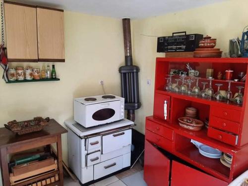 a kitchen with a white stove and red cabinets at Vila Eva in Međuvršje