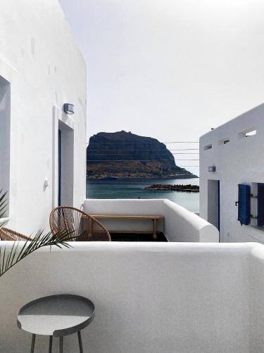 a balcony with a bench and a table and chairs at LULU - Self Catering Accommodation in Monemvasia
