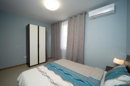 a bedroom with a bed and a large window at Villa Angels Golf in Balchik