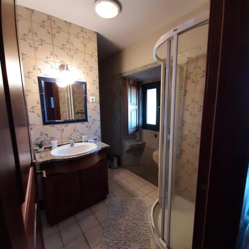 a bathroom with a sink and a shower at Quinta do Real - Casa de Campo in Viana do Castelo