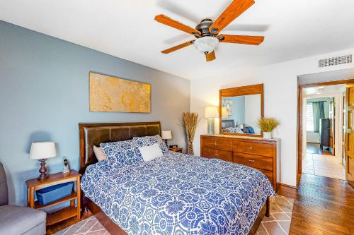a bedroom with a bed and a ceiling fan at Red Roof Retreat in Rancho Mirage
