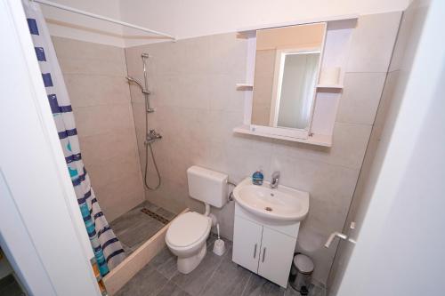 a small bathroom with a toilet and a sink at House Relax in Selca