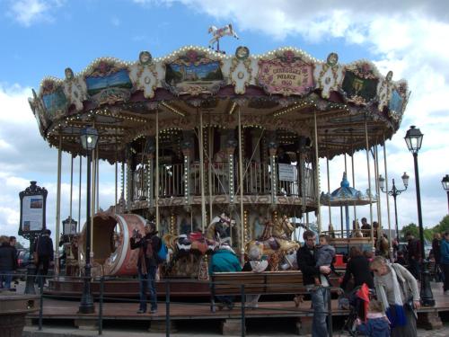 a group of people standing on a carousel at Hôtel Monet in Honfleur
