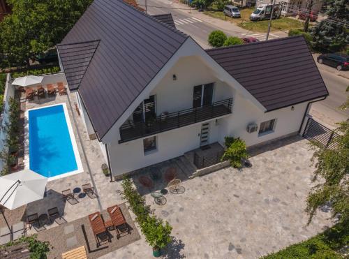 an overhead view of a house with a swimming pool at Vila Pobeda in Banja Koviljača