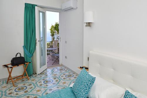 Postel nebo postele na pokoji v ubytování Malafemmena Guest House