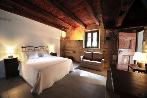 a bedroom with a bed and a chair in a room at Borgo Selvapiana in Morbegno