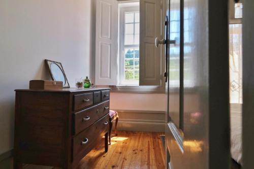 a room with a dresser and a window in it at Casa de São Roque - Lamego in Cambres