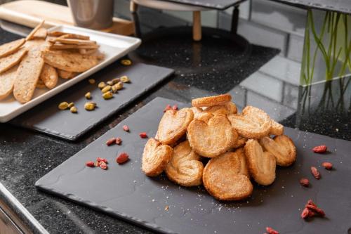 a pile of bread on a cutting board on a table at Park Inn by Radisson, Riyadh in Riyadh