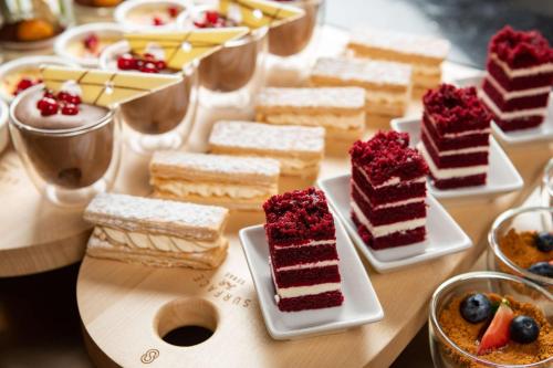a table topped with different types of cakes and desserts at Park Inn by Radisson, Riyadh in Riyadh