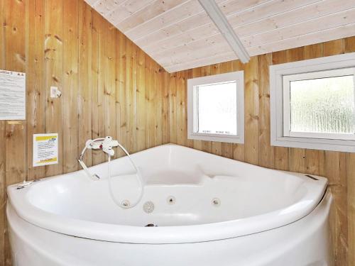 a white tub in a room with two windows at 8 person holiday home in Melby in Melby