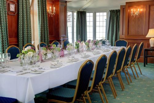 a long table in a room with chairs at The Grange at Oborne in Sherborne