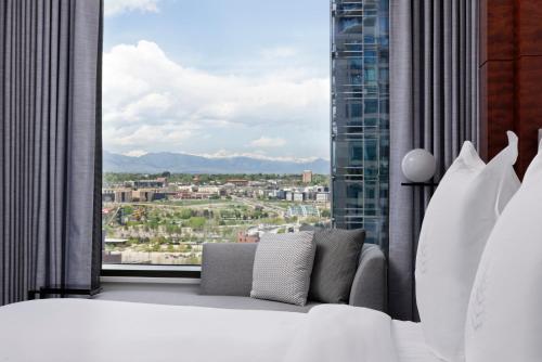 a bedroom with a large window with a view at Four Seasons Hotel Denver in Denver