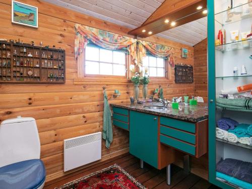 a bathroom with a sink in a log cabin at Holiday home Middelfart II in Middelfart