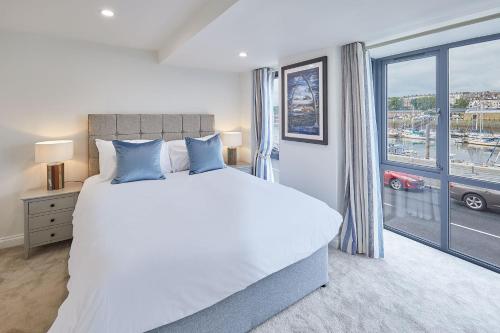 a bedroom with a large bed and a large window at Host & Stay - The Townhouse in Whitby