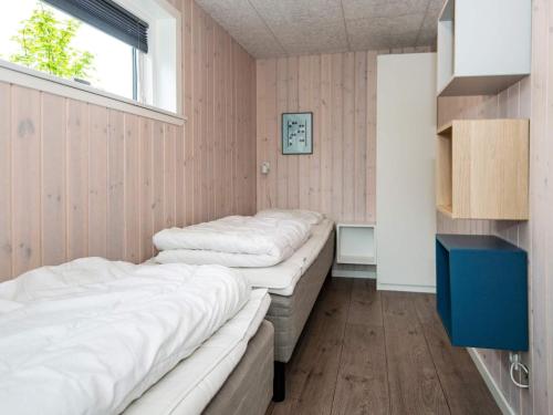 two beds in a room with a window at Holiday home Ebeltoft XXI in Ebeltoft