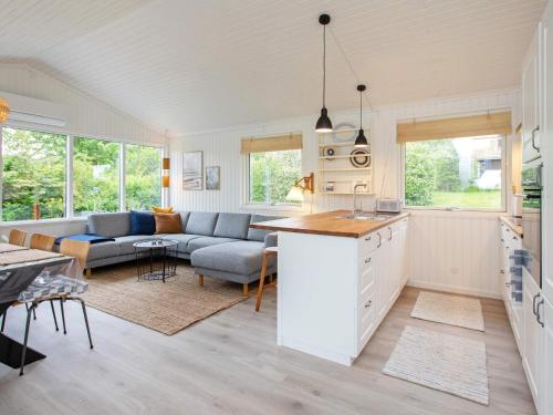 a kitchen and living room with a couch and a table at 6 person holiday home in Karreb ksminde in Karrebæksminde