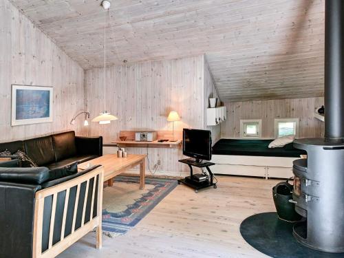 a living room with a couch and a bed in a room at Quaint Holiday Home in Nex with Beach nearby in Vester Sømarken