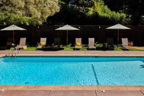 a swimming pool with chairs and umbrellas at Highlands Resort - Adults Only in Guerneville