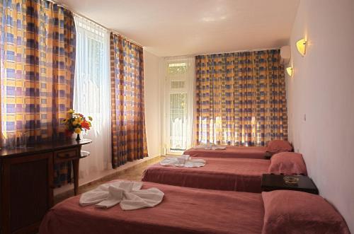 A bed or beds in a room at Sunny Varshava Hotel