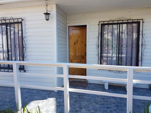 a front porch of a house with wrought iron gates at CABAÑA QUISQUEÑA in El Quisco