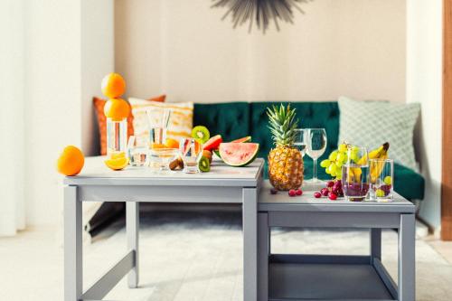 two tables with drinks and fruit on them at Section L Residence Asakusa East in Tokyo