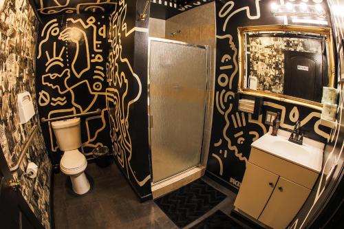 a bathroom with a toilet and a sink at The Rosemary in Los Angeles