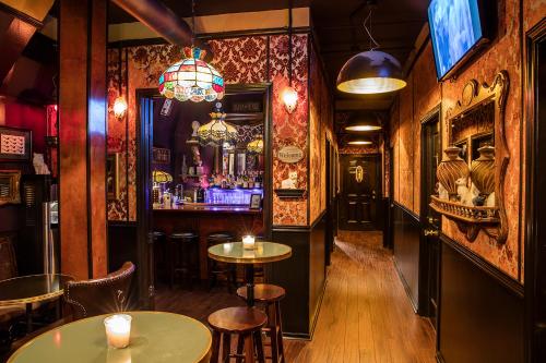 a bar with tables and chairs in a pub at The Rosemary in Los Angeles