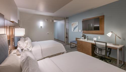 a hotel room with two beds and a television at EVEN Hotel Atlanta - Cobb Galleria, an IHG Hotel in Atlanta