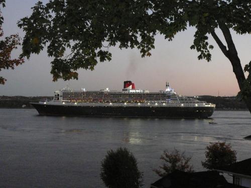 a large cruise ship on the water at Goéliche hotel et appartement in Saint-Laurent-de-l'ile d'Orleans