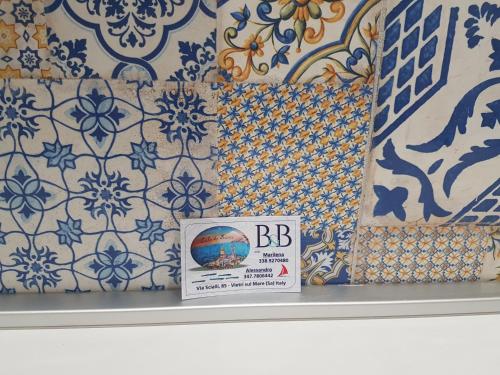 a shelf with blue and white tiles on a wall at Cala Di Luna House in Vietri sul Mare