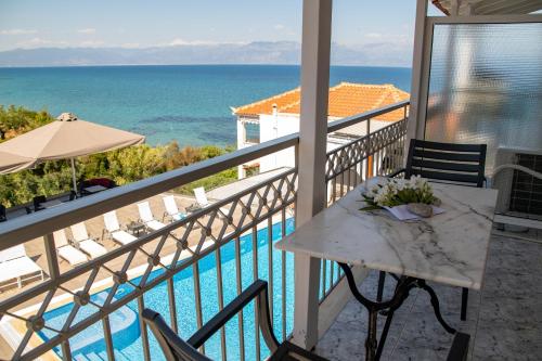 a balcony with a table and a view of the ocean at Panorama Apartments in Chrani