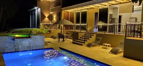 a house with a swimming pool at night at Mountain View Anapoima in Anapoima