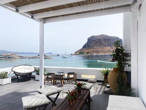 a patio with a view of the ocean and a mountain at LULU - Self Catering Accommodation in Monemvasia