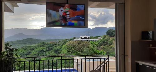 a room with a window with a view of a mountain at Mountain View Anapoima in Anapoima