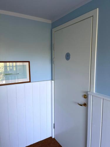 a door is open to a room with a blue wall at Egn Bed & Breakfast in Stege