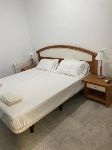 מיטה או מיטות בחדר ב-Aloja Madrid