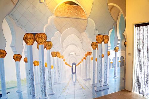 a room with a wall painting of a mosque at 依比鴨鴨水岸會館 Ducking House in Ruisui