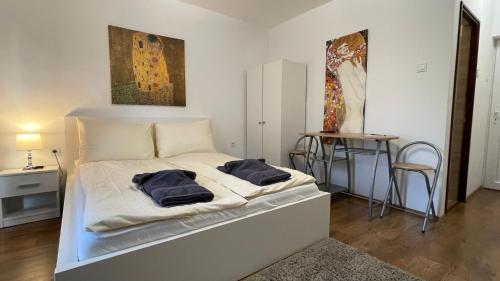 a bedroom with a bed with two pillows on it at CITY Apartman in Balatonföldvár