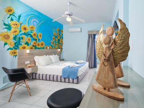 a bedroom with a bed with a flower mural at Aptera Beach in Amoudara Herakliou