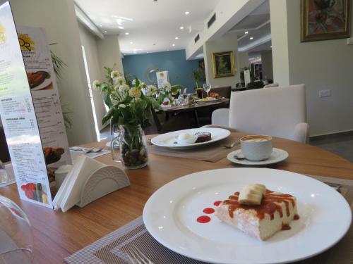 a piece of cake on a plate on a table at Hotel Sun in North Nicosia