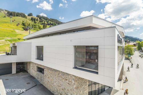 an aerial view of a white building at Appartements Bernhofer in Saalbach Hinterglemm