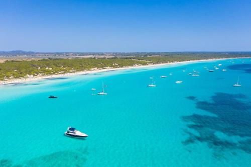 an aerial view of boats in a large body of water at The Blue Beach Apartment in Sa Ràpita