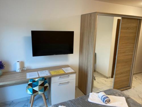 a hotel room with a desk and a tv on the wall at Belamionix motel in Bosanski Šamac
